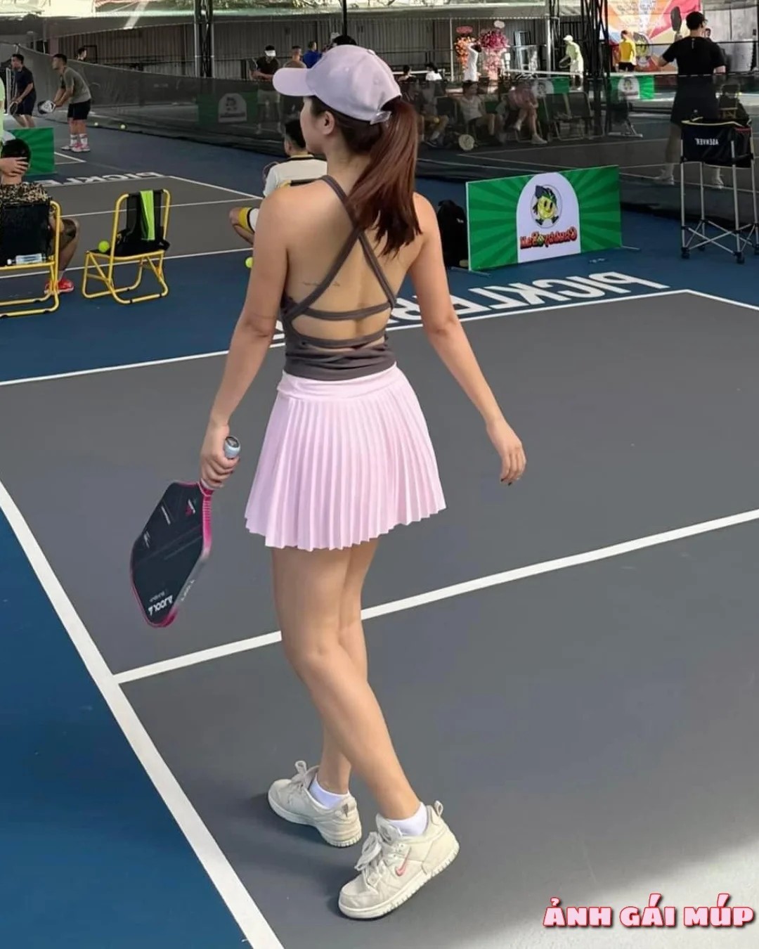 Cô gái chơi pickleball với tư thế nghỉ ngơi
